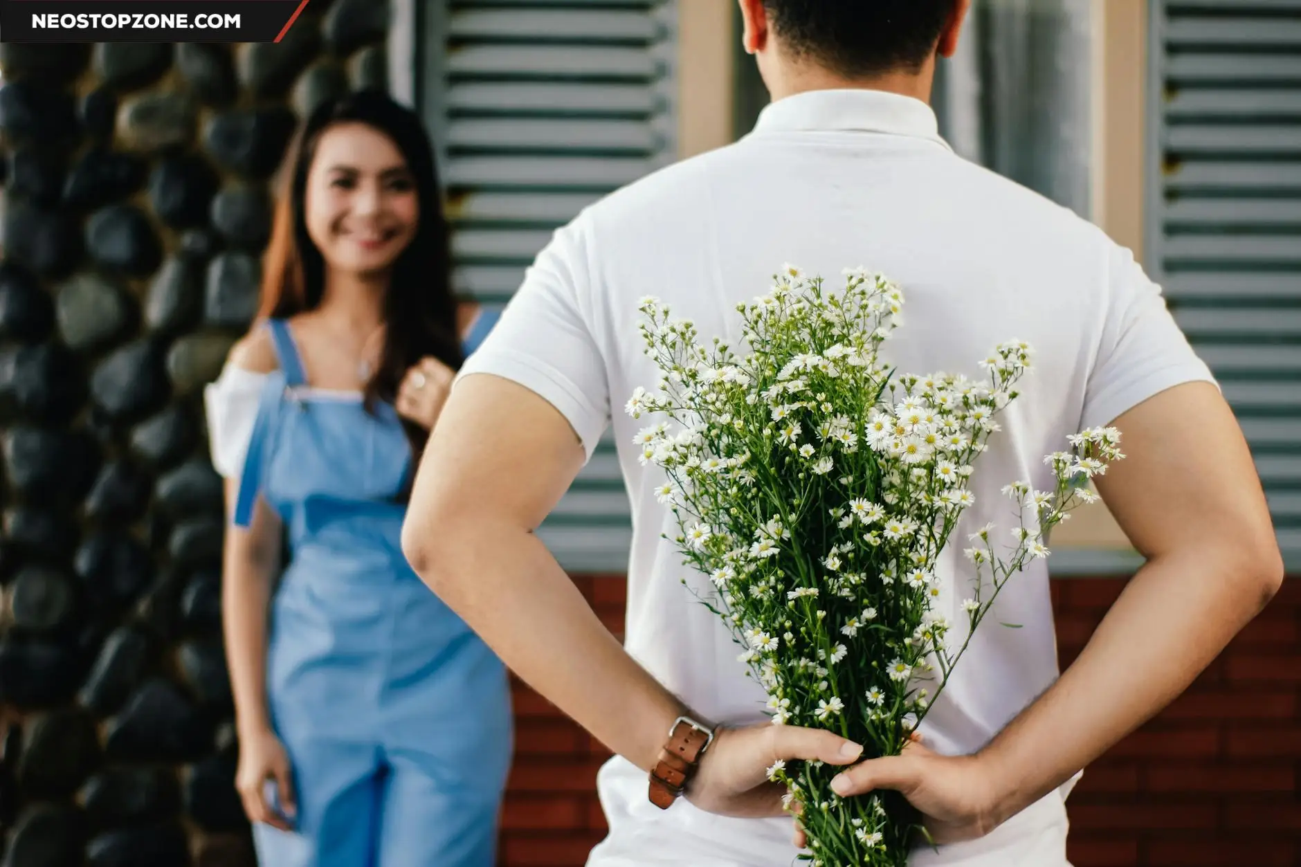 https://www.pexels.com/photo/man-holding-baby-s-breath-flower-in-front-of-woman-standing-near-marble-wall-935789/